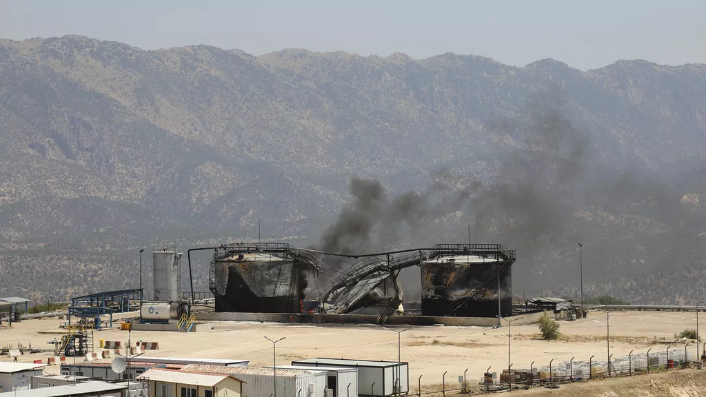 Black smoke rises from damaged oil storage tanks f